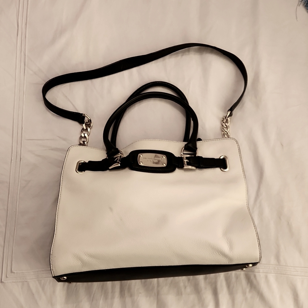 Black and white Michael Kors purse with gold accents